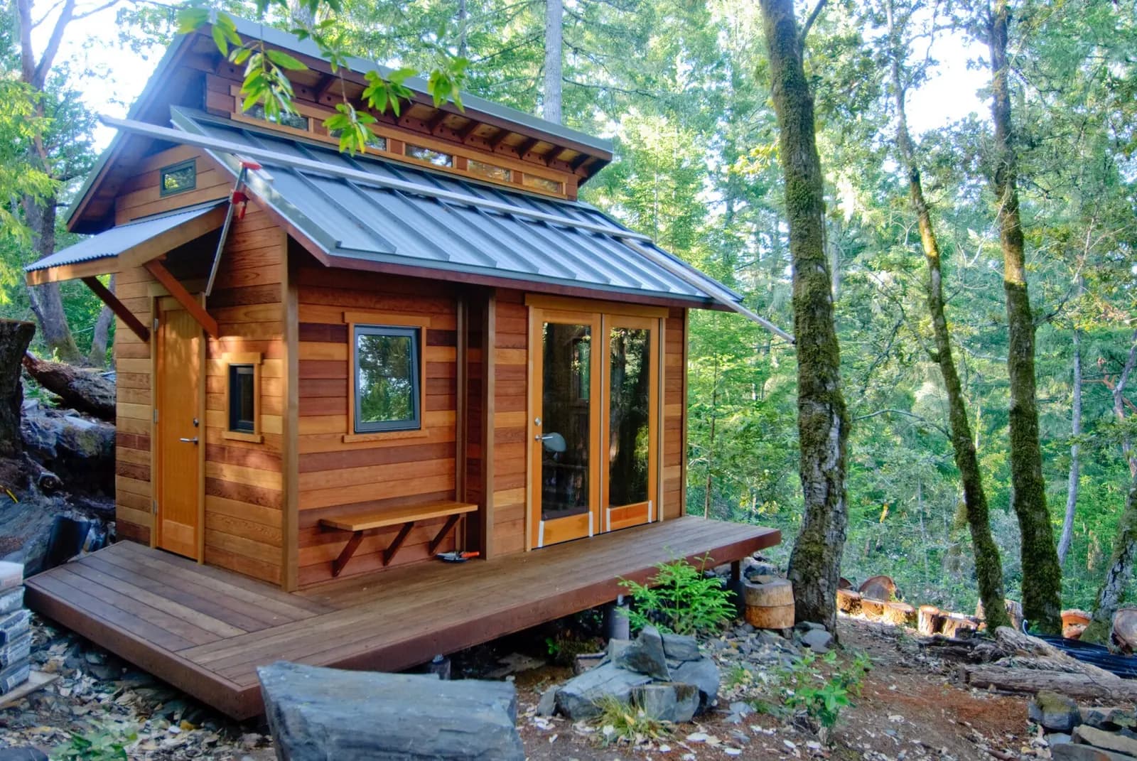 A small detached wood cottage with a deck. Shown on the homepage for Oakland, CA.